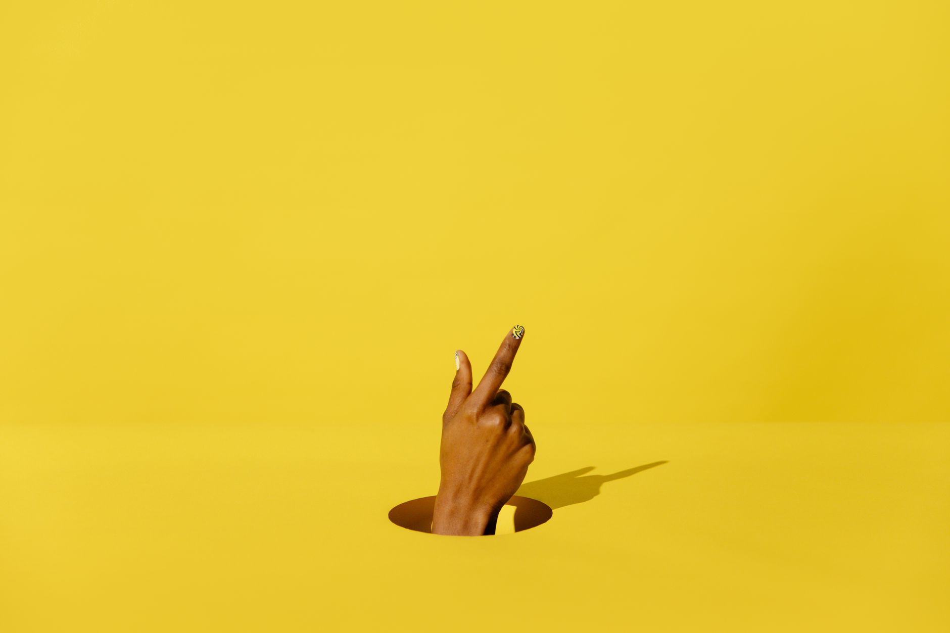 person s hand in yellow background