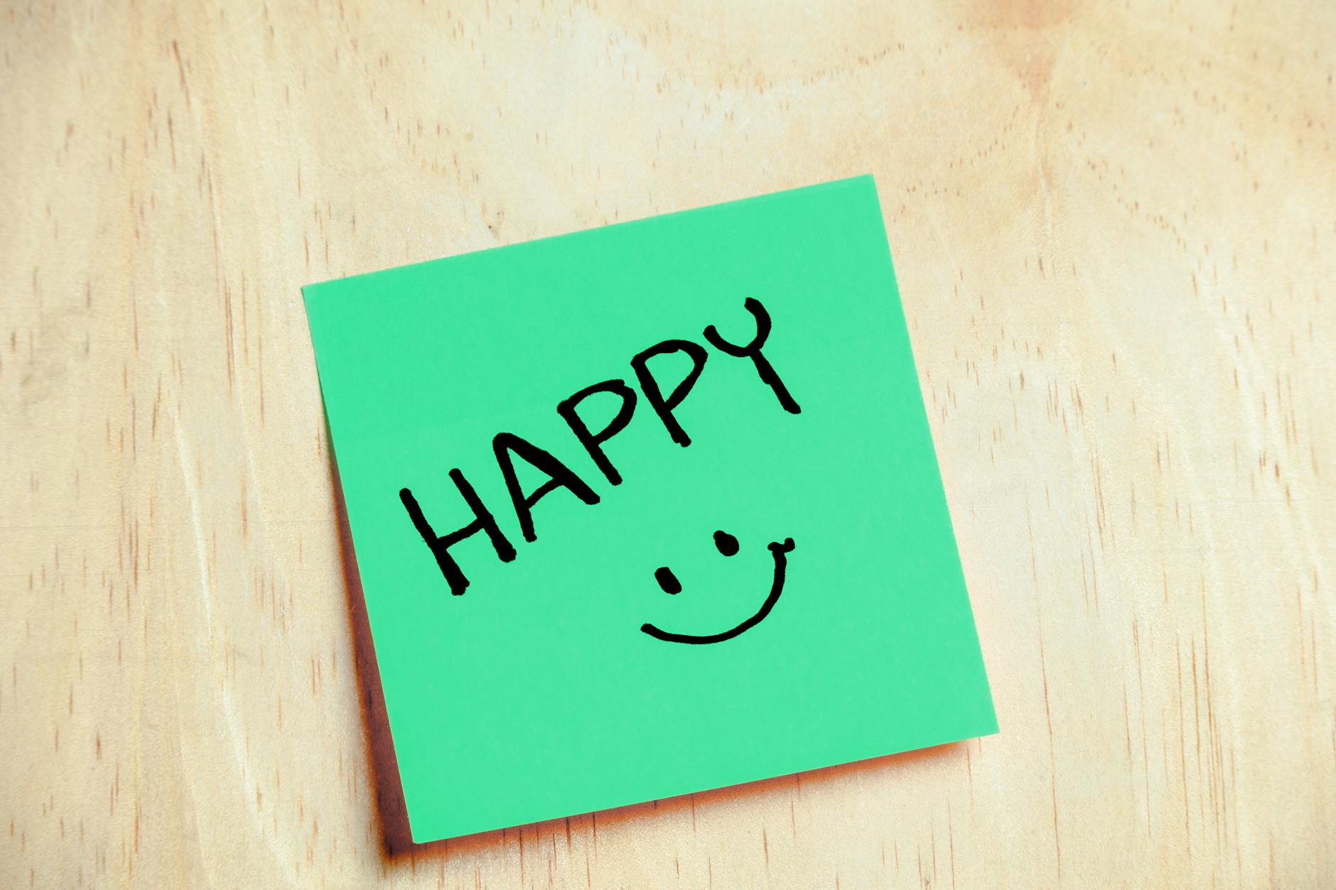 green sticky note with happy message
