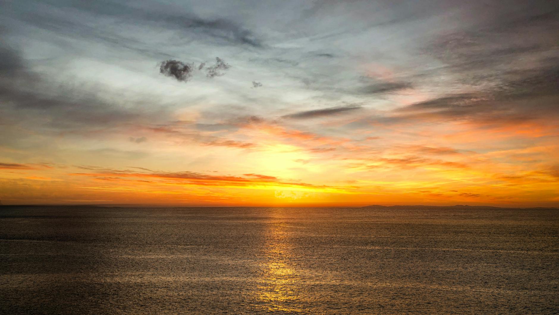 scenic view of an ocean during golden hour