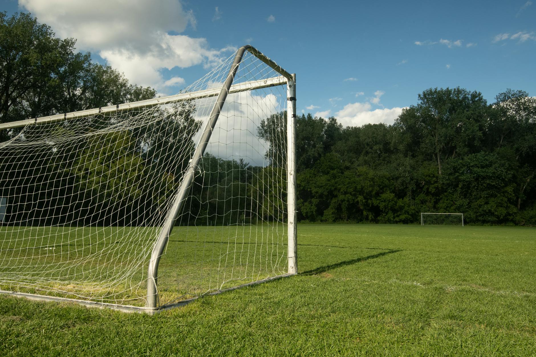 soccer field surrounded by trees
