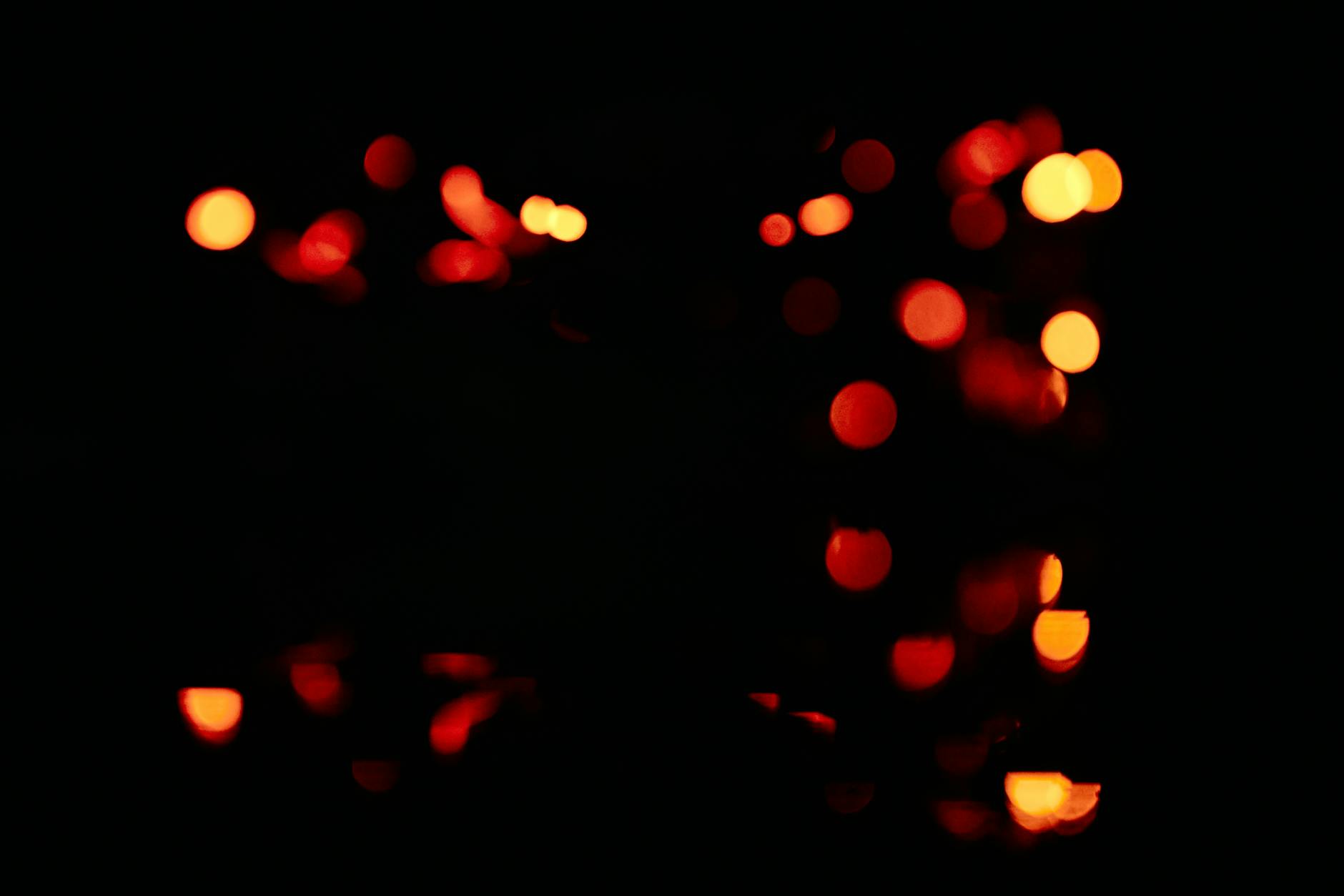 unfocused blur orange light dots on black background