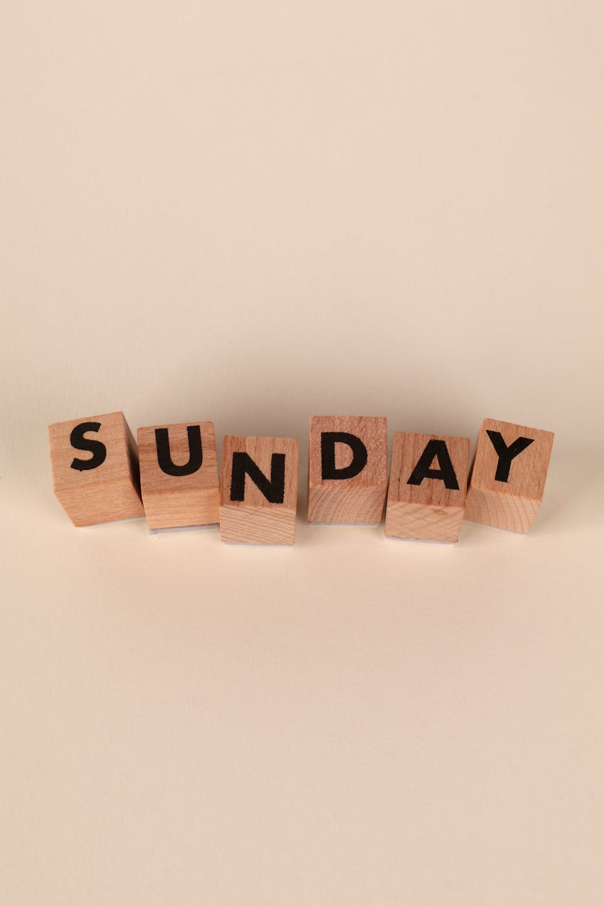 wooden blocks spelling sunday on neutral background