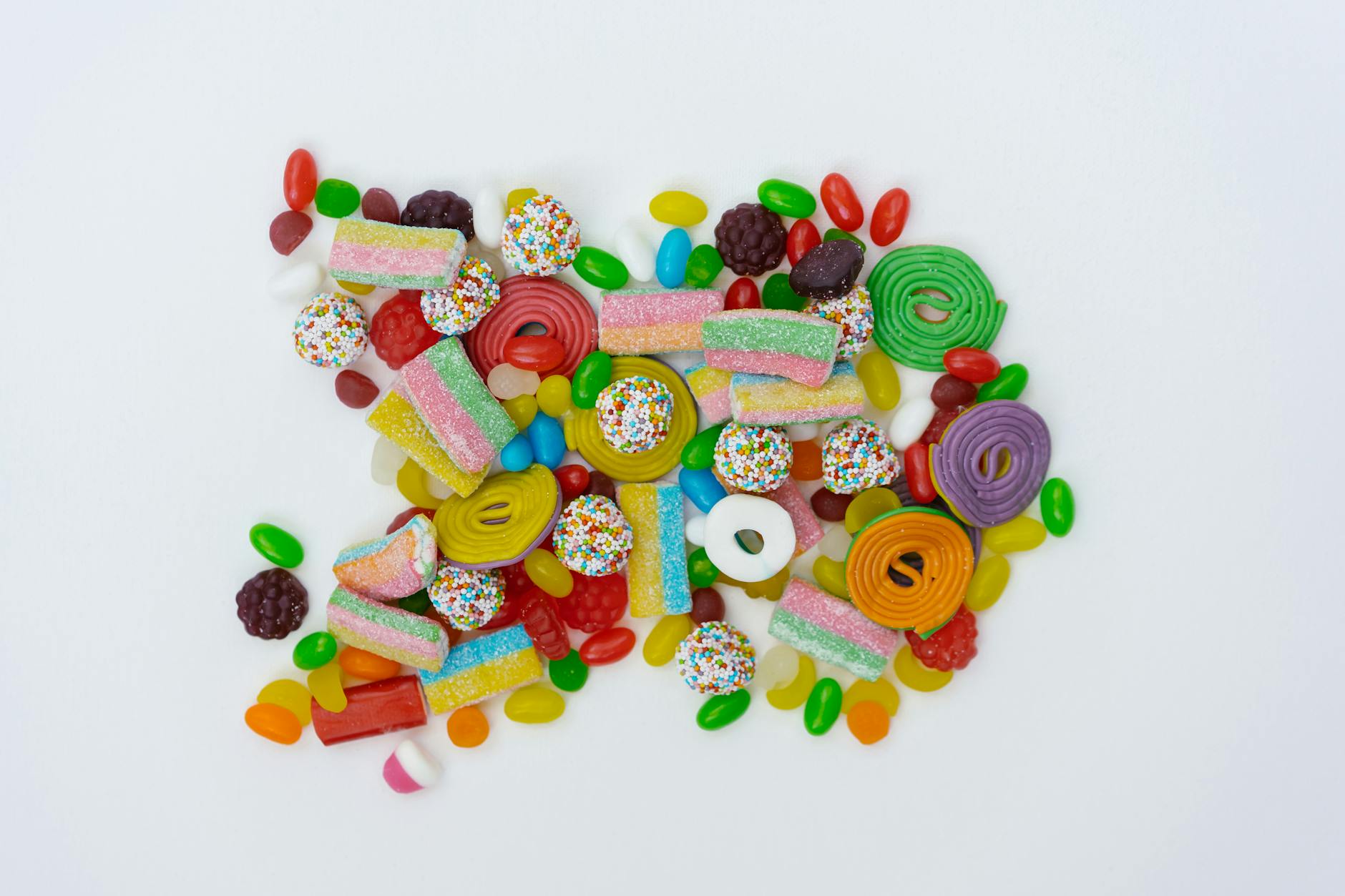 close up shot of assorted candies on a white surface