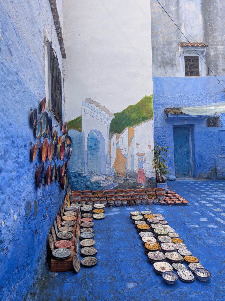 Lots of crockery for sale on a blue floor with blue walls